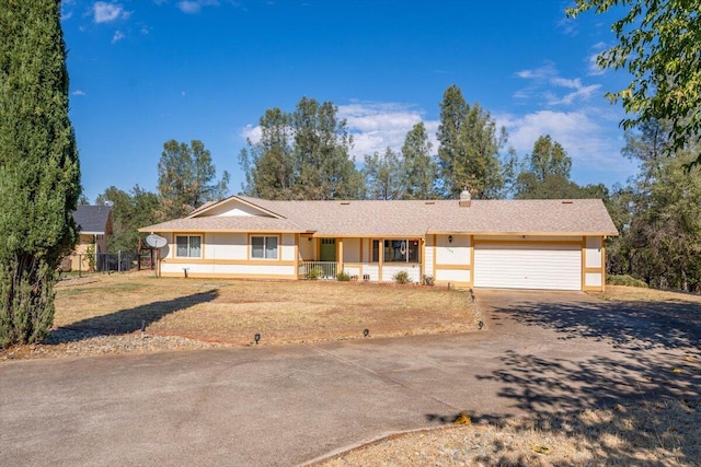 ranch-style house with a front yard, a garage, and a porch