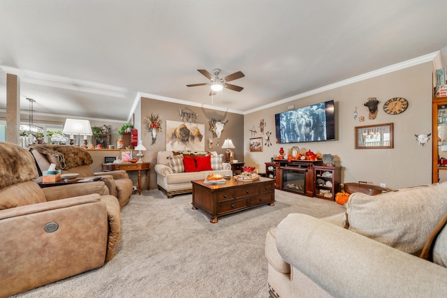 carpeted living room featuring ceiling fan and crown molding