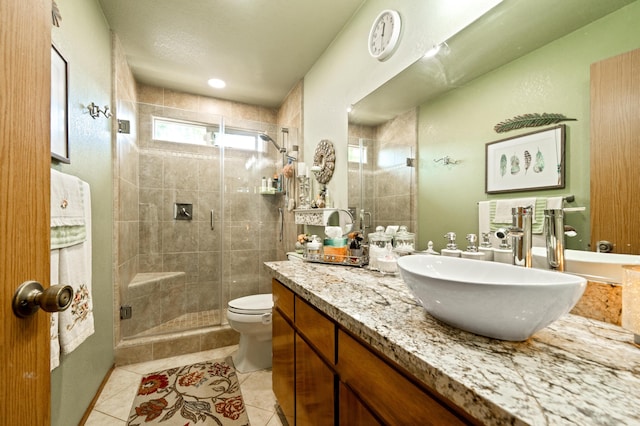 bathroom featuring vanity, toilet, walk in shower, and tile patterned flooring