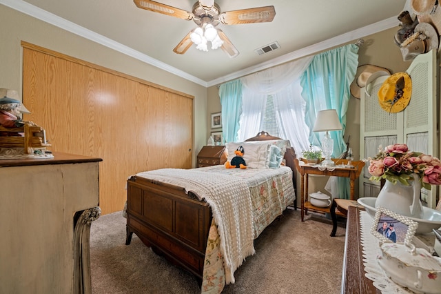 bedroom featuring ceiling fan, ornamental molding, and carpet floors