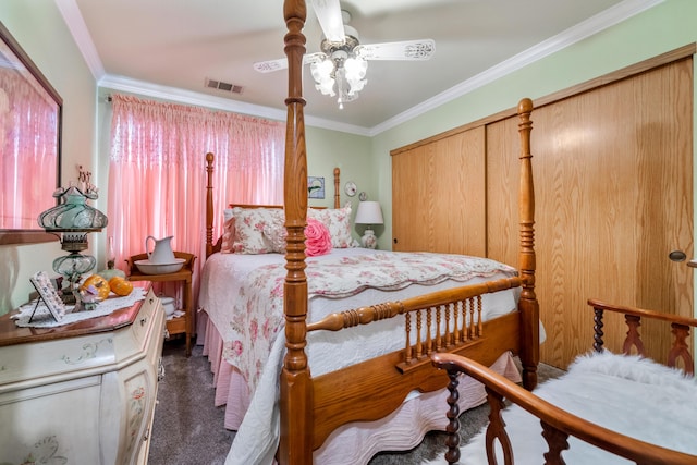 bedroom with ceiling fan, dark carpet, a closet, and ornamental molding