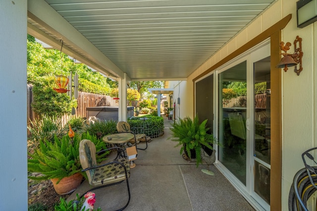 view of patio / terrace with a hot tub