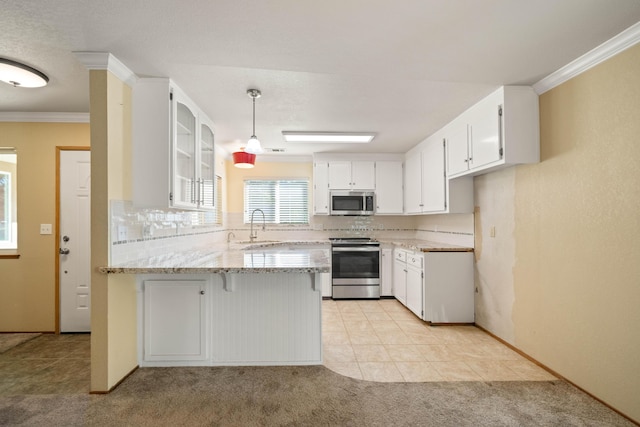 6849 Creekside St, Redding, CA 96001 - kitchen featuring stainless steel appliances, a peninsula, a sink, tasteful backsplash, and white cabinetry