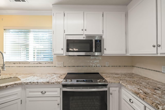 6849 Creekside St, Redding, CA 96001 - kitchen with appliances with stainless steel finishes, white cabinets, a sink, tasteful backsplash, and crown molding