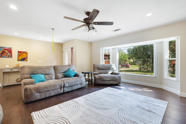 living room featuring ceiling fan and dark hardwood / wood-style floors