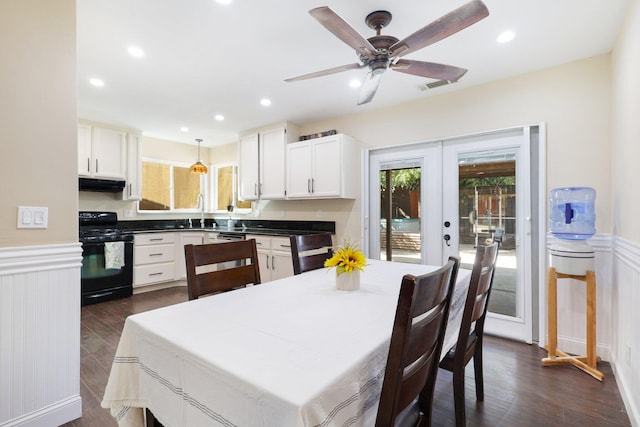 dining room featuring dark wood-type flooring, french doors, sink, and ceiling fan