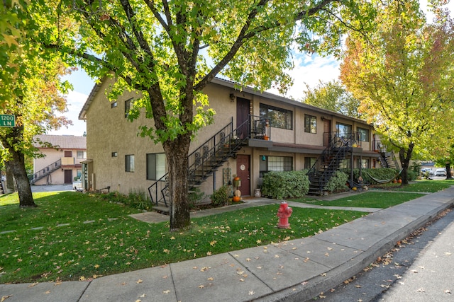 view of front of property with a front yard and a garage