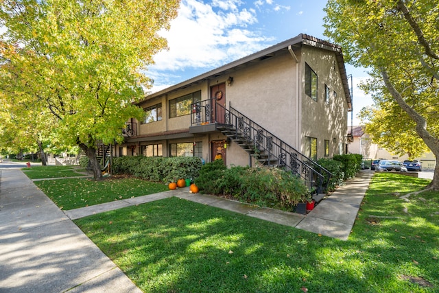 view of property exterior with a yard