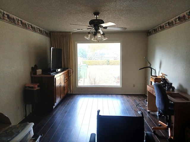 living room featuring a textured ceiling, ceiling fan, and dark hardwood / wood-style floors