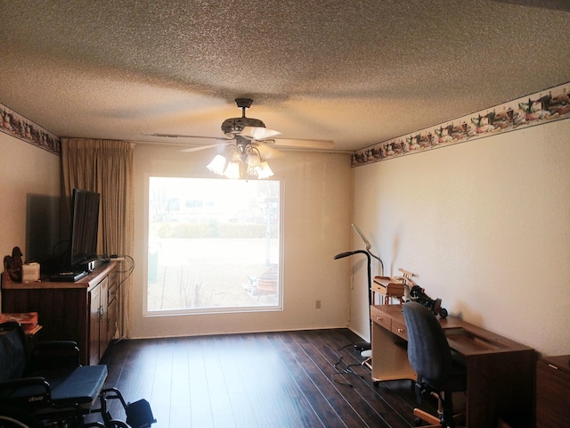 home office featuring a textured ceiling, ceiling fan, and dark wood-type flooring