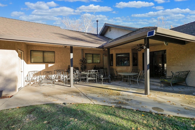 back of house with ceiling fan and a patio