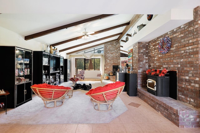 tiled living room with vaulted ceiling with beams, ceiling fan, a wood stove, and brick wall