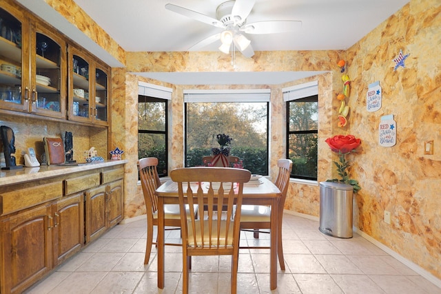 tiled dining room featuring ceiling fan