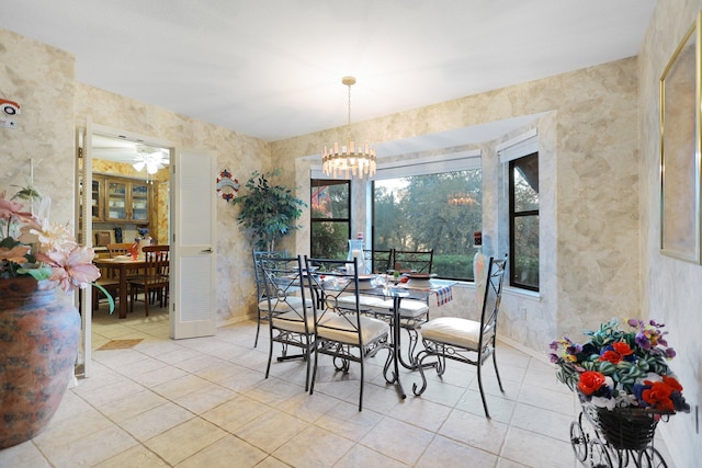 tiled dining space with a chandelier