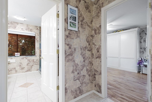 bathroom with tile patterned flooring and a textured ceiling