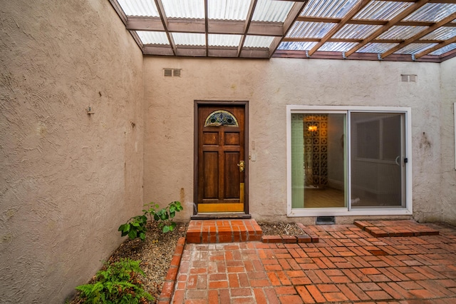 entrance to property with a pergola and a patio area