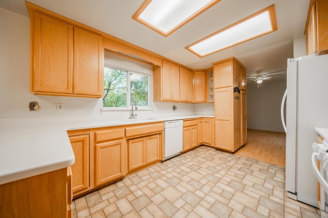 kitchen with light brown cabinets, sink, white appliances, ceiling fan, and light hardwood / wood-style flooring