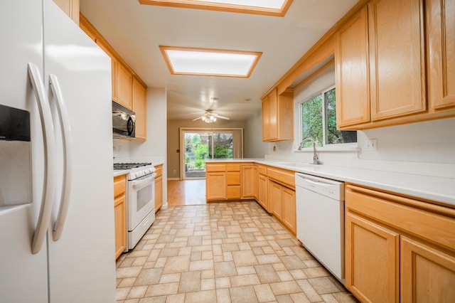 kitchen with light brown cabinetry, sink, white appliances, and ceiling fan