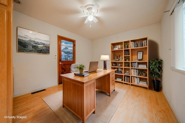 home office featuring ceiling fan and light hardwood / wood-style flooring