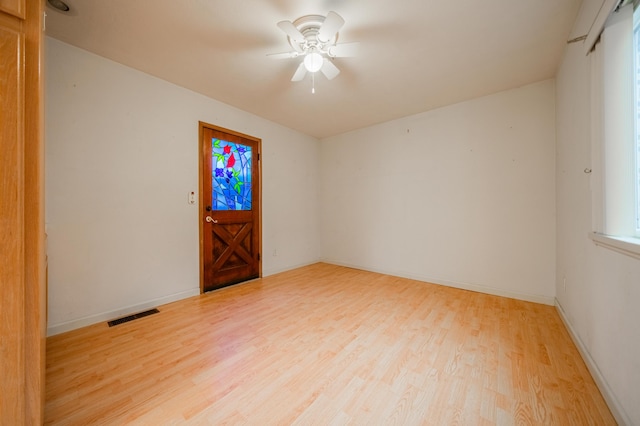 empty room with hardwood / wood-style flooring and ceiling fan