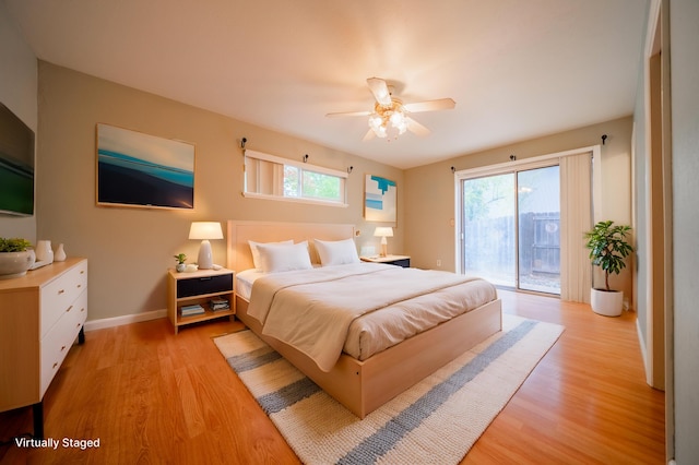 bedroom featuring ceiling fan, access to exterior, multiple windows, and light wood-type flooring