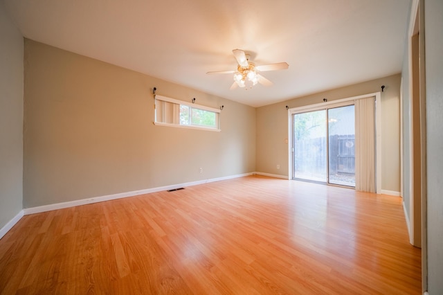 empty room featuring light hardwood / wood-style floors, ceiling fan, and plenty of natural light