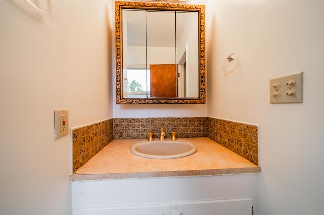 bathroom featuring vanity and backsplash