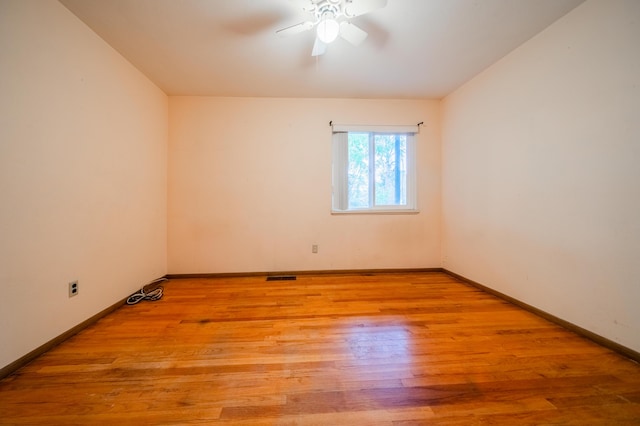 empty room featuring ceiling fan and light hardwood / wood-style floors