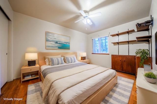 bedroom featuring ceiling fan, wood-type flooring, and a closet