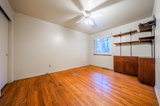 unfurnished bedroom featuring light hardwood / wood-style flooring, ceiling fan, and a closet