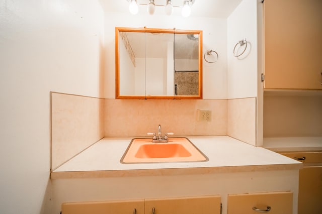 bathroom featuring vanity and tasteful backsplash