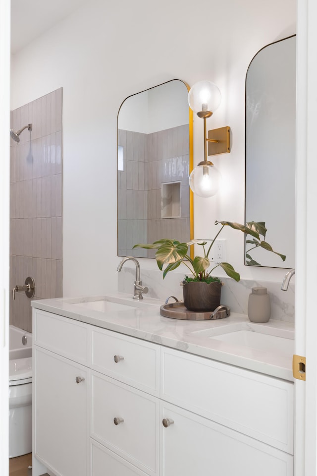 full bathroom with vanity, toilet, and tiled shower / bath combo