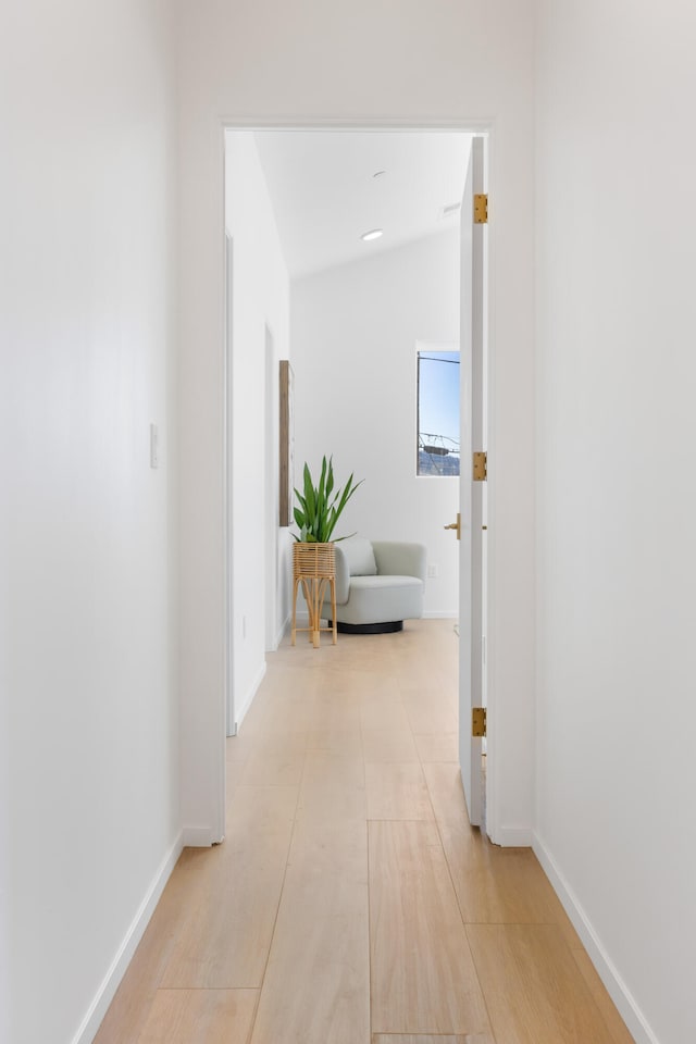 corridor featuring lofted ceiling