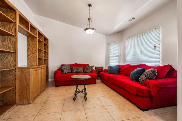 living room featuring lofted ceiling and light tile patterned floors