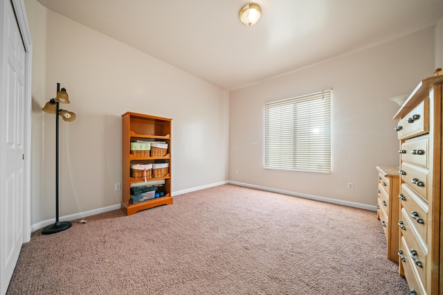 interior space with lofted ceiling and light carpet