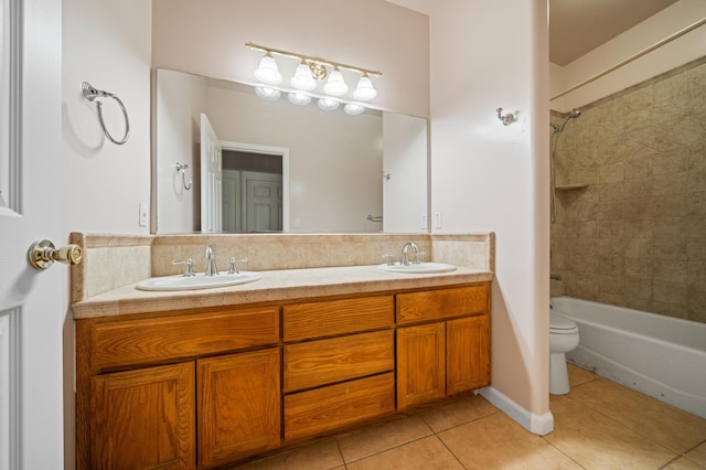 full bathroom with vanity, tiled shower / bath combo, toilet, and tile patterned flooring