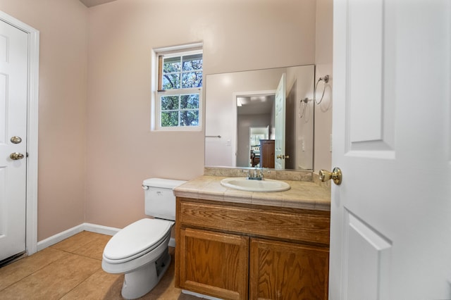 bathroom featuring vanity, toilet, and tile patterned floors