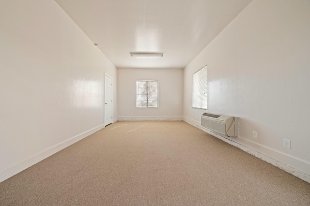 empty room with light carpet and a wall mounted AC