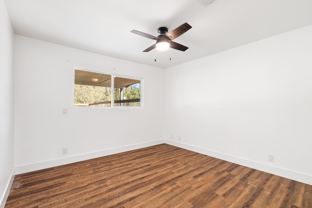 unfurnished room featuring dark wood-type flooring and ceiling fan