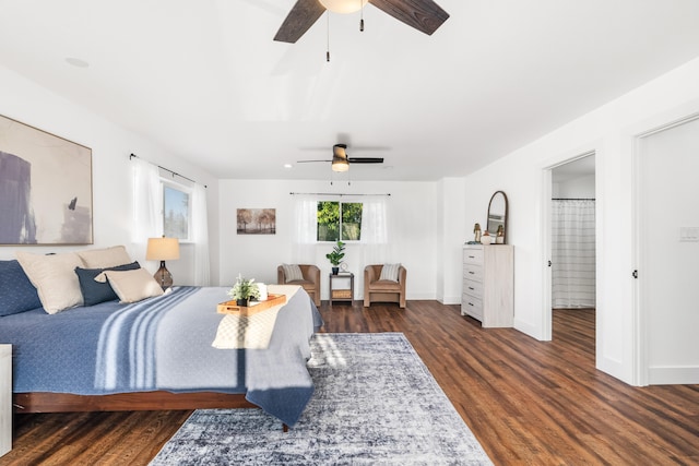 bedroom featuring connected bathroom, ceiling fan, and dark hardwood / wood-style flooring