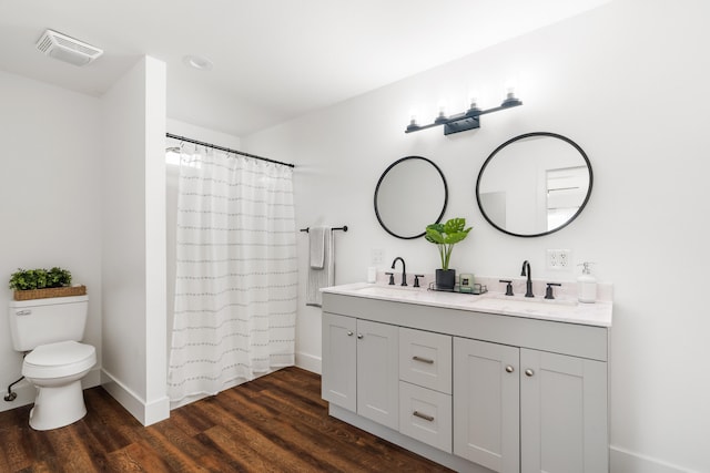 bathroom with vanity, toilet, a shower with shower curtain, and hardwood / wood-style floors