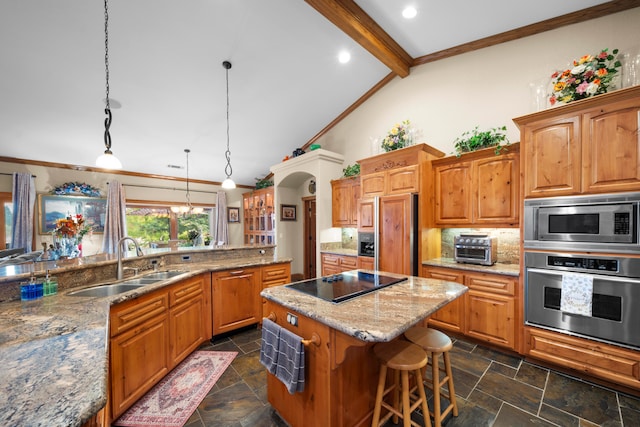 kitchen with beam ceiling, hanging light fixtures, built in appliances, sink, and a center island