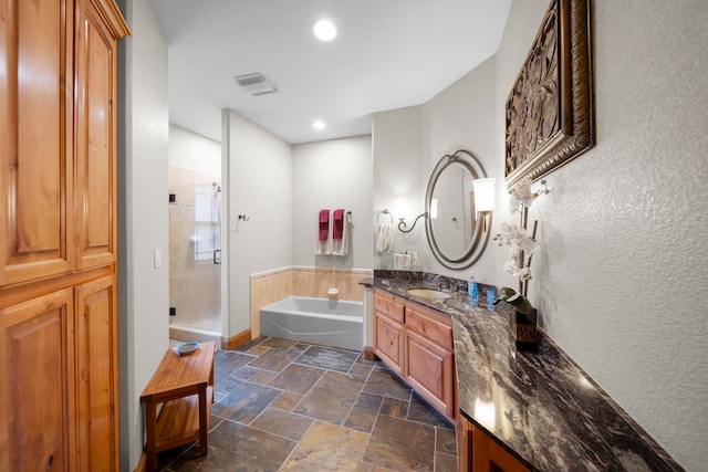 bathroom with vanity and separate shower and tub