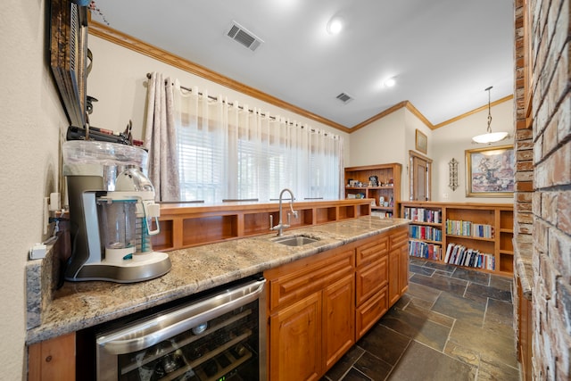 kitchen featuring wine cooler, hanging light fixtures, vaulted ceiling, crown molding, and sink