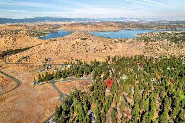 drone / aerial view featuring a water and mountain view