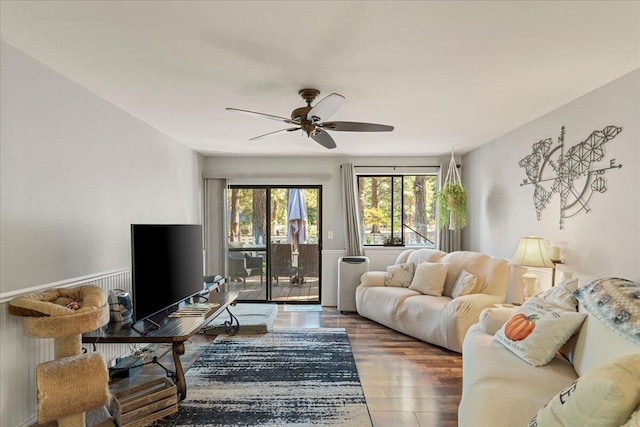 living room with ceiling fan and hardwood / wood-style flooring