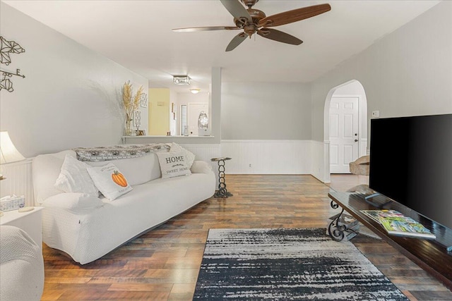 living room featuring wood-type flooring and ceiling fan