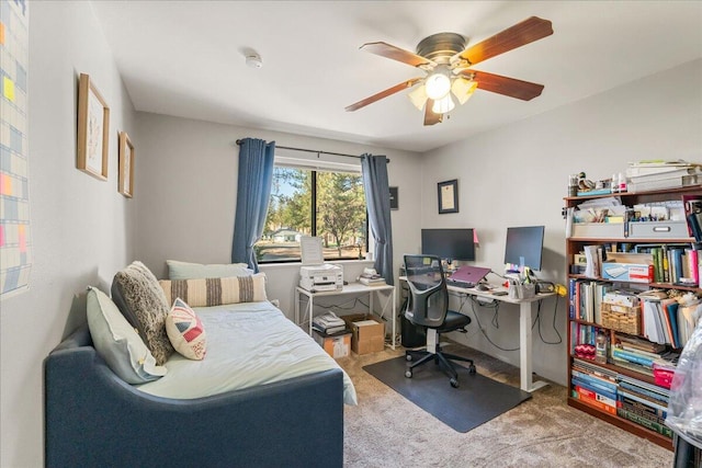 carpeted office space with ceiling fan