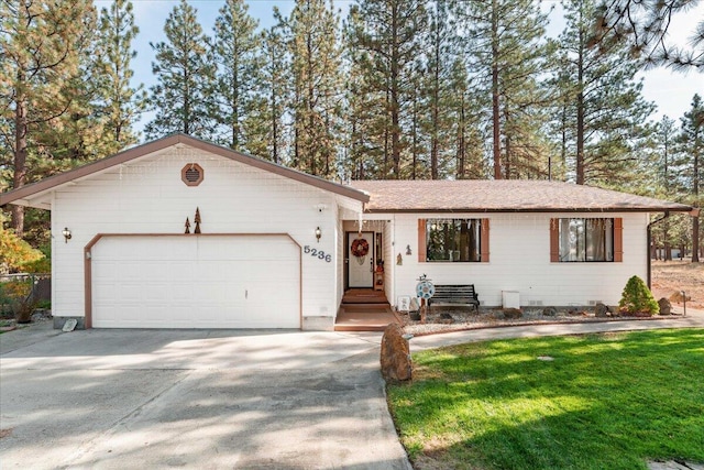 ranch-style house featuring a front yard and a garage