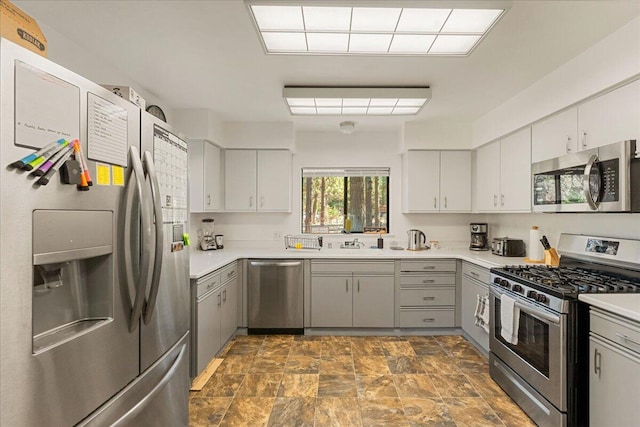 kitchen with stainless steel appliances and gray cabinets